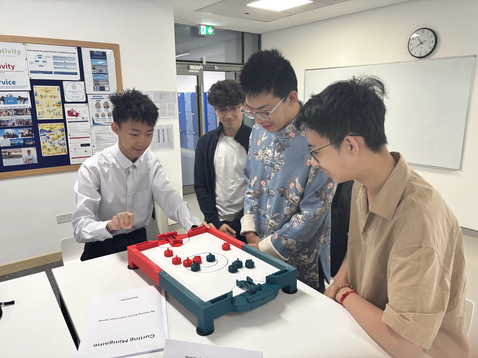 Students testing the tabletop curling game