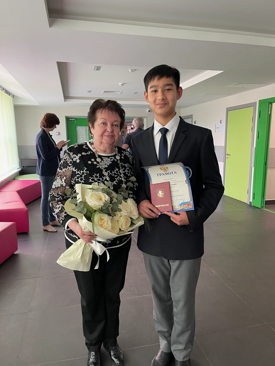 Yiming Aizezi with his classical piano teacher at graduation
