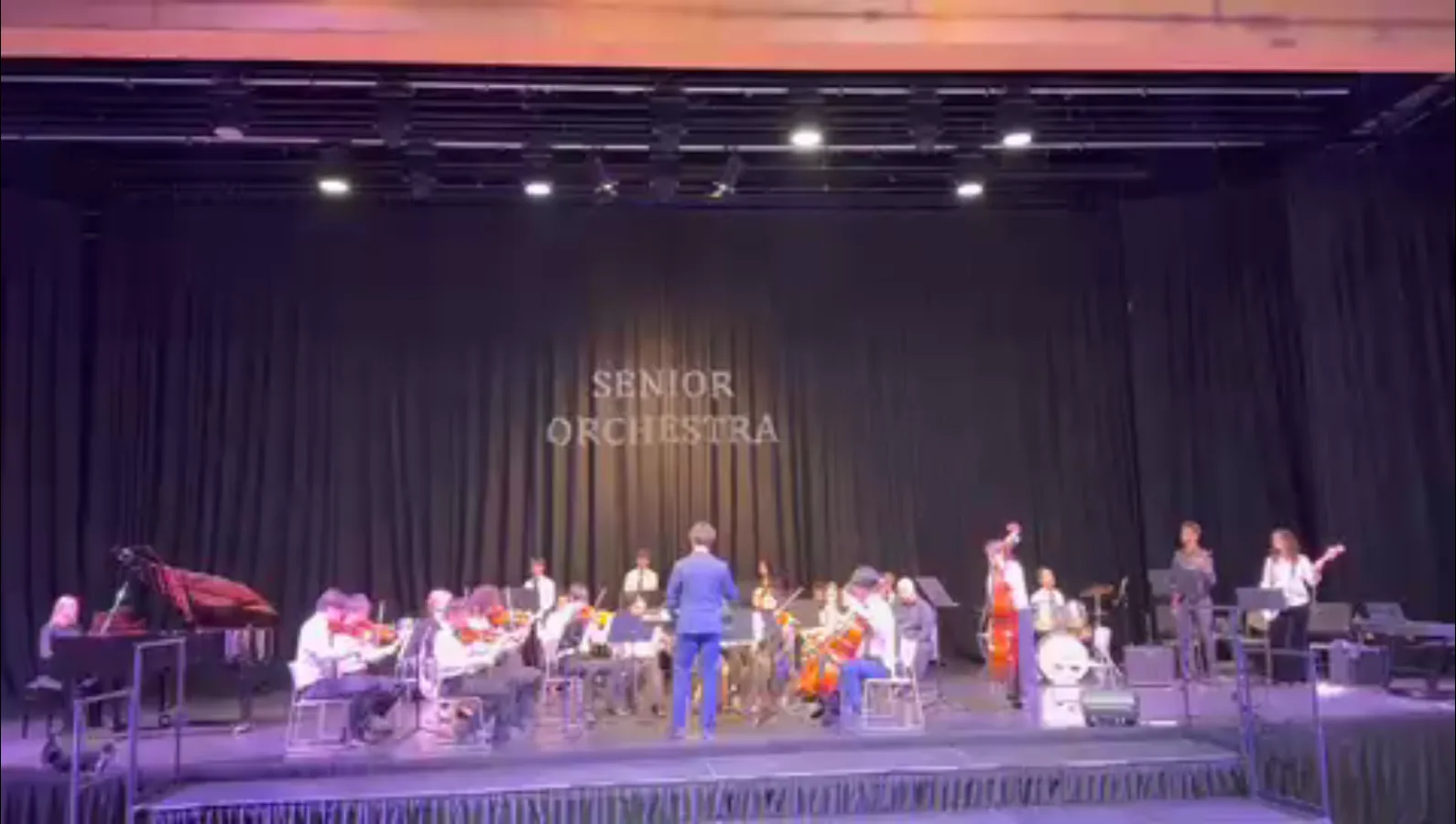 Yiming conducting a live performance of his original orchestral composition